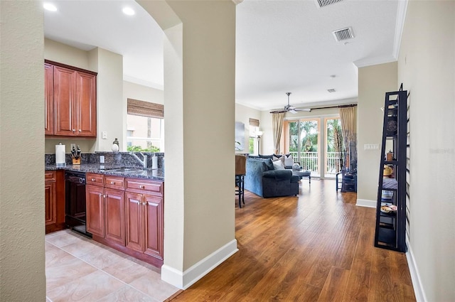 kitchen featuring crown molding, visible vents, and a sink