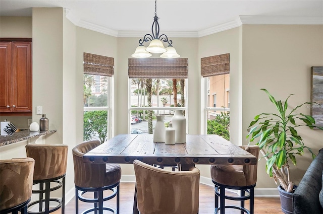 dining space featuring crown molding and light wood-type flooring