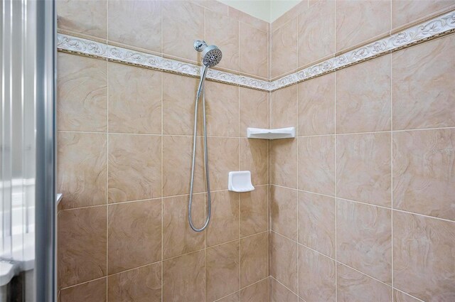 interior details with a tile shower