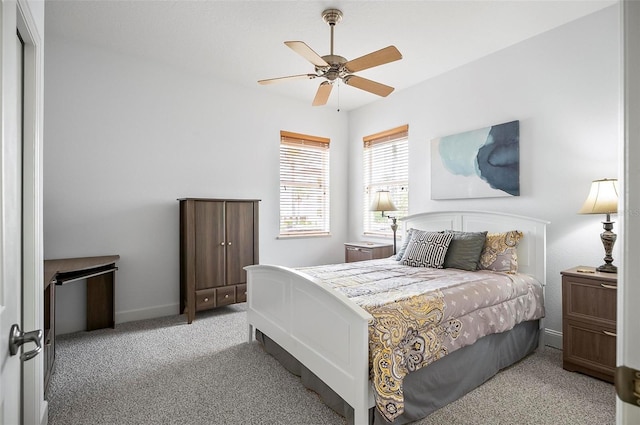 carpeted bedroom featuring ceiling fan and baseboards