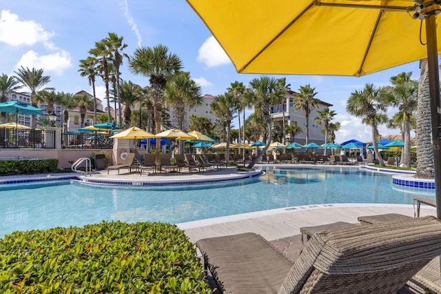 community pool featuring fence and a patio