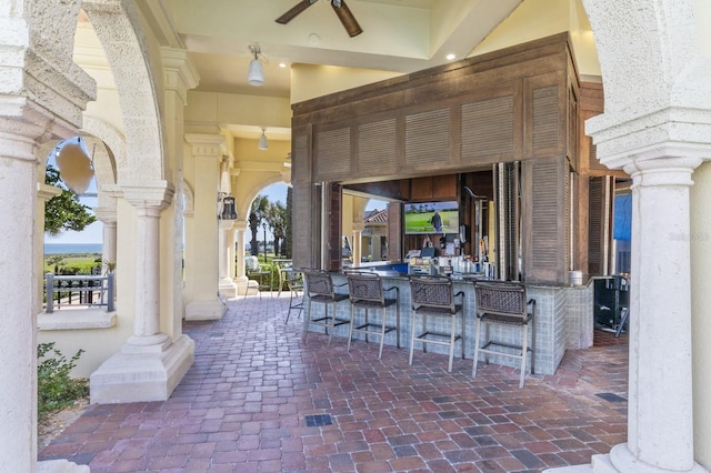 view of patio / terrace with ceiling fan and outdoor dry bar