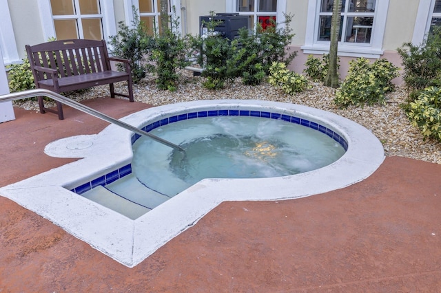 view of swimming pool featuring an in ground hot tub