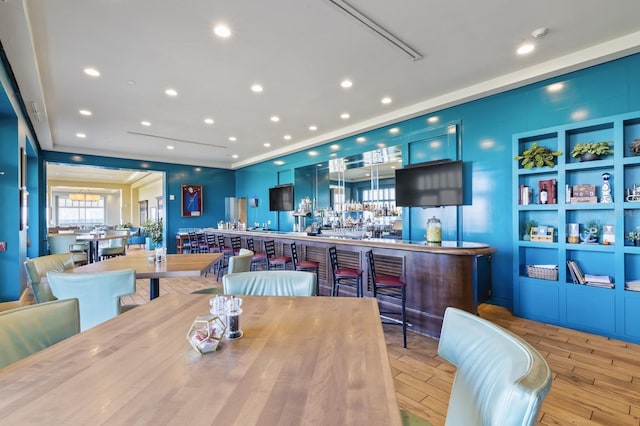 dining space with wood finished floors and recessed lighting