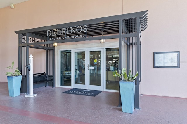 entrance to property with french doors and stucco siding