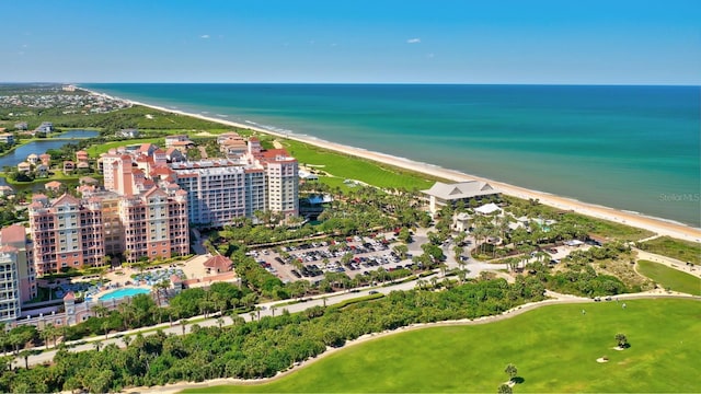 drone / aerial view featuring a water view and a beach view