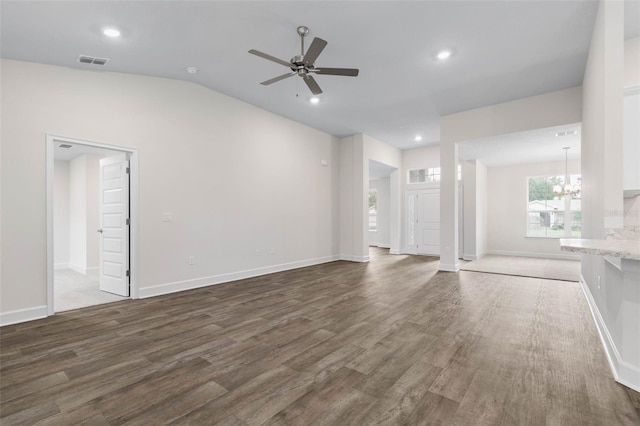 unfurnished living room featuring recessed lighting, ceiling fan with notable chandelier, visible vents, and dark wood-style flooring