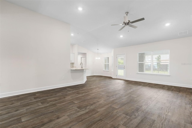 unfurnished living room featuring visible vents, dark wood-style floors, baseboards, ceiling fan, and vaulted ceiling