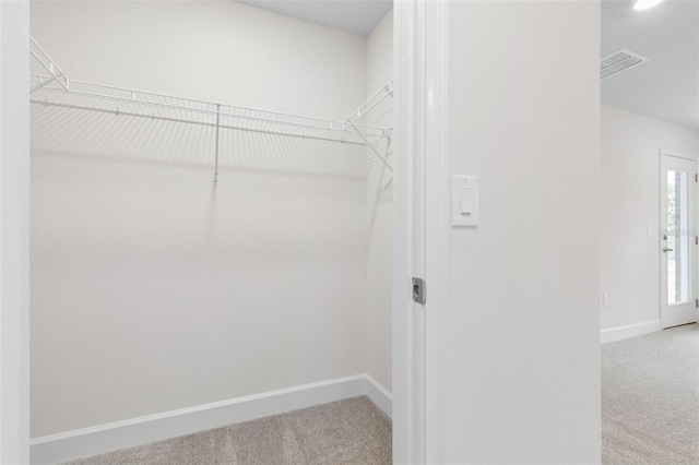 spacious closet featuring carpet flooring and visible vents