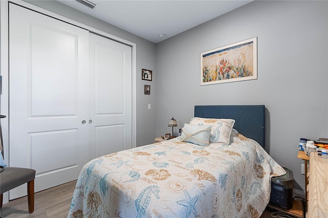 bedroom with hardwood / wood-style flooring and a closet