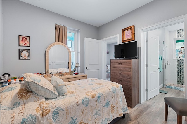 bedroom with a closet and light hardwood / wood-style flooring