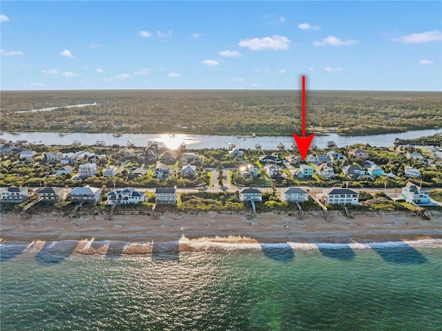 drone / aerial view featuring a water view and a beach view