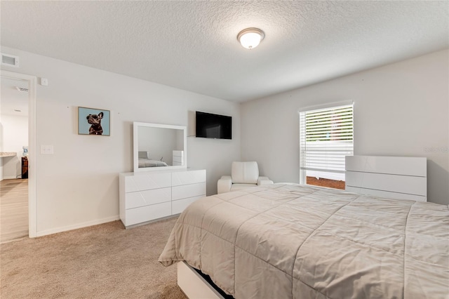 carpeted bedroom featuring a textured ceiling