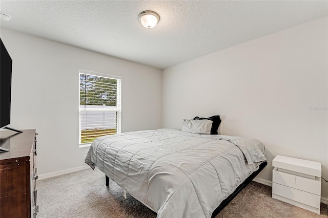 carpeted bedroom featuring a textured ceiling