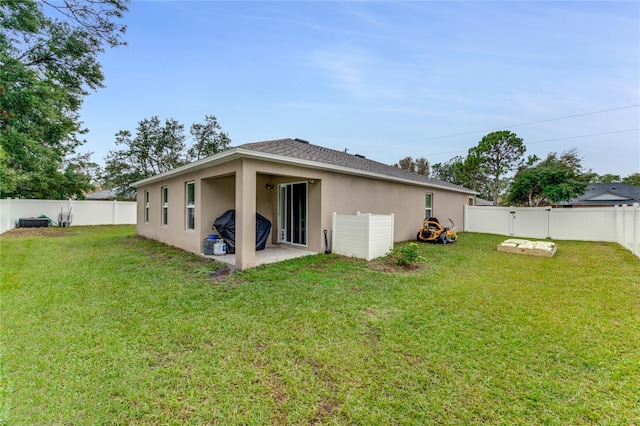 back of property featuring a patio and a lawn