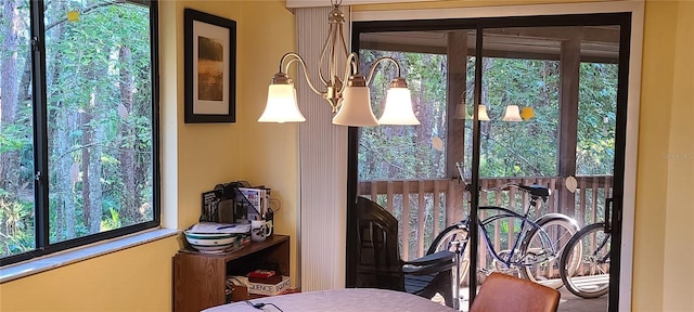 bedroom with multiple windows and an inviting chandelier