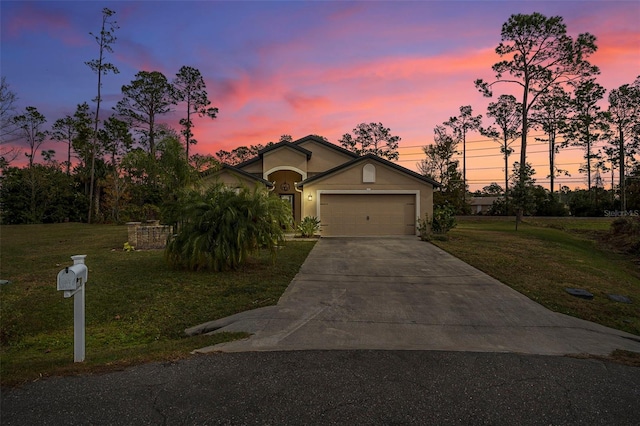 view of front of home featuring a lawn and a garage