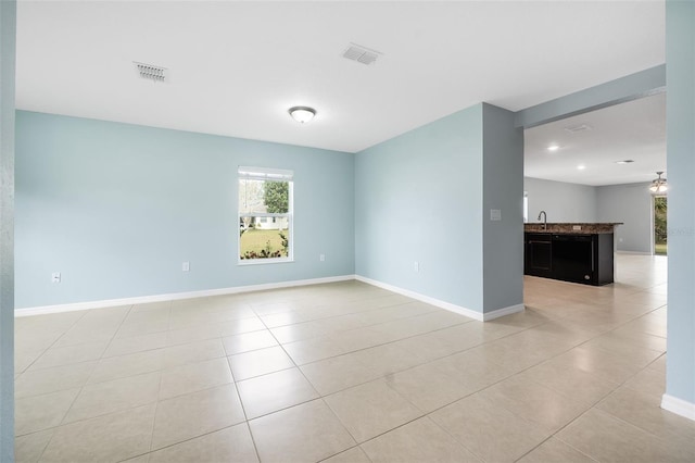 empty room featuring light tile patterned floors and sink