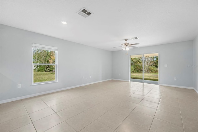 tiled empty room with ceiling fan