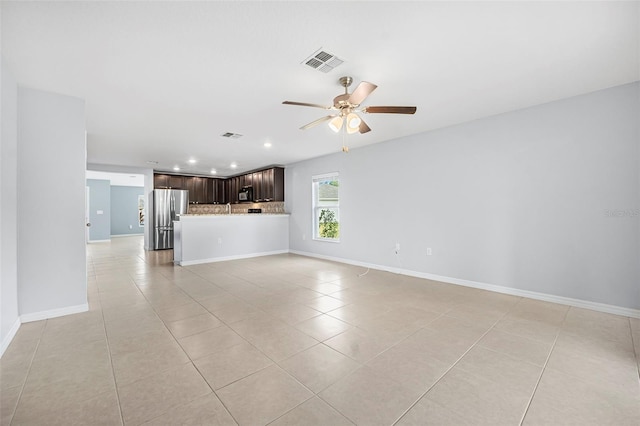 unfurnished living room featuring ceiling fan and light tile patterned floors