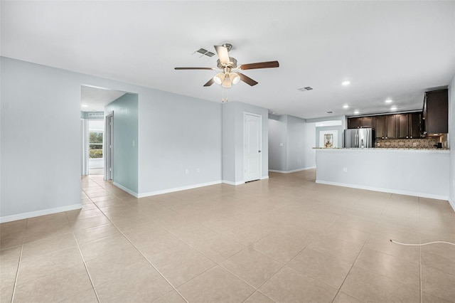 unfurnished living room with ceiling fan and light tile patterned floors