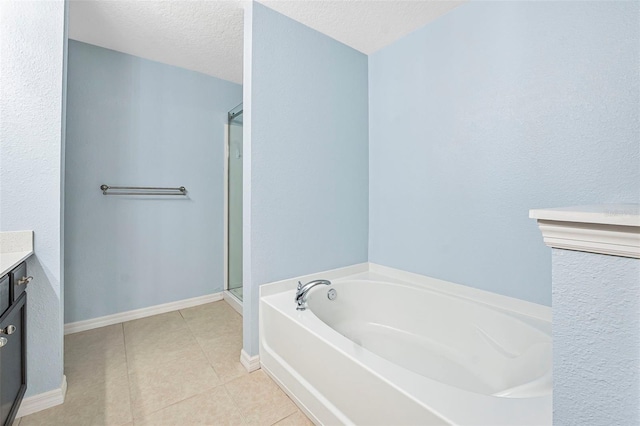 bathroom with tile patterned flooring, vanity, separate shower and tub, and a textured ceiling