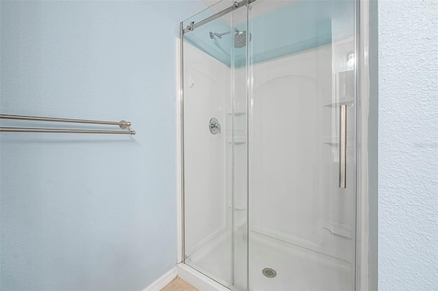 bathroom with a shower with shower door