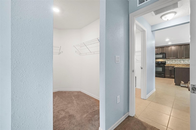 spacious closet with light colored carpet