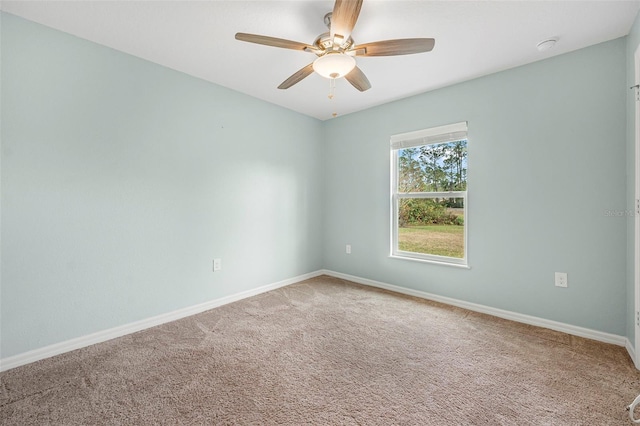 spare room featuring carpet flooring and ceiling fan