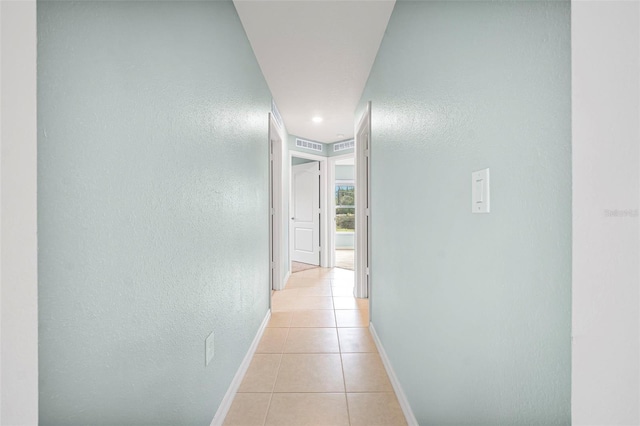 hallway with light tile patterned floors