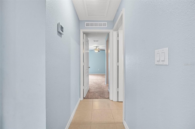 hall with light tile patterned floors