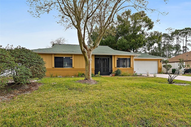 ranch-style home with a garage and a front lawn