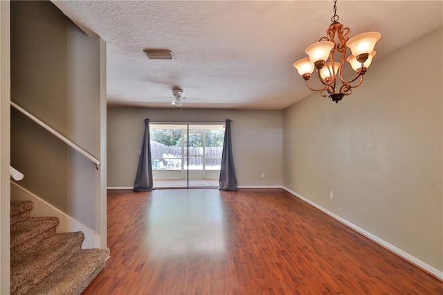 unfurnished room featuring a textured ceiling, wood-type flooring, and ceiling fan with notable chandelier