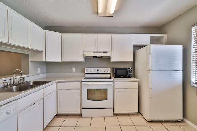 kitchen with sink, light tile patterned floors, a textured ceiling, white appliances, and white cabinets