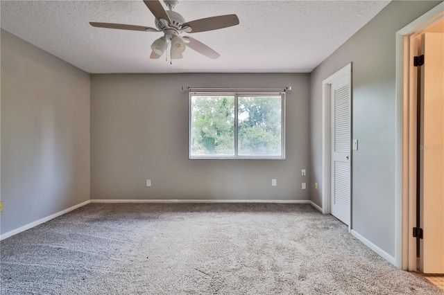 unfurnished bedroom featuring carpet, ceiling fan, and a textured ceiling