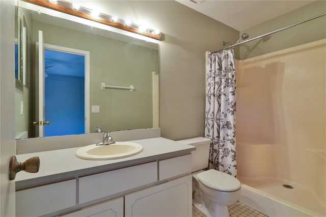 bathroom with tile patterned flooring, vanity, toilet, and curtained shower