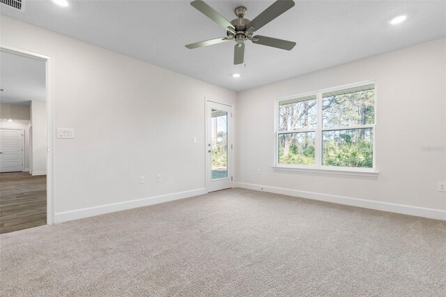 carpeted empty room featuring ceiling fan