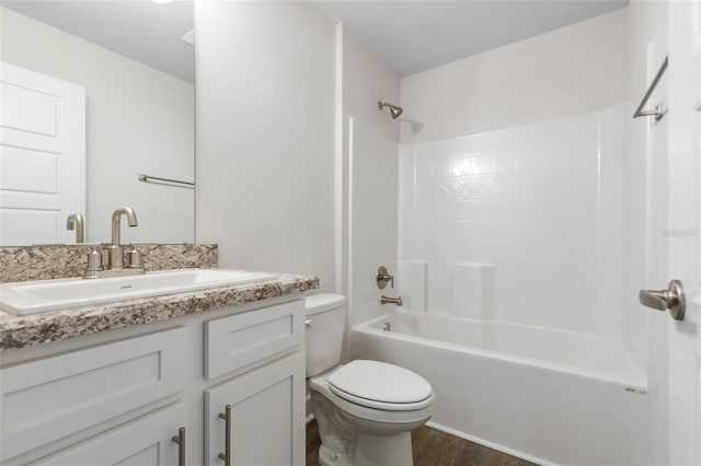 full bathroom featuring toilet, shower / tub combination, hardwood / wood-style floors, and vanity