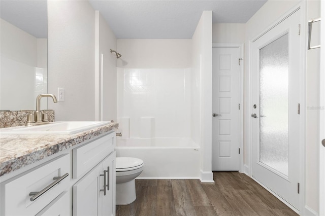 full bathroom with wood-type flooring, vanity, plenty of natural light, toilet, and shower / bathtub combination