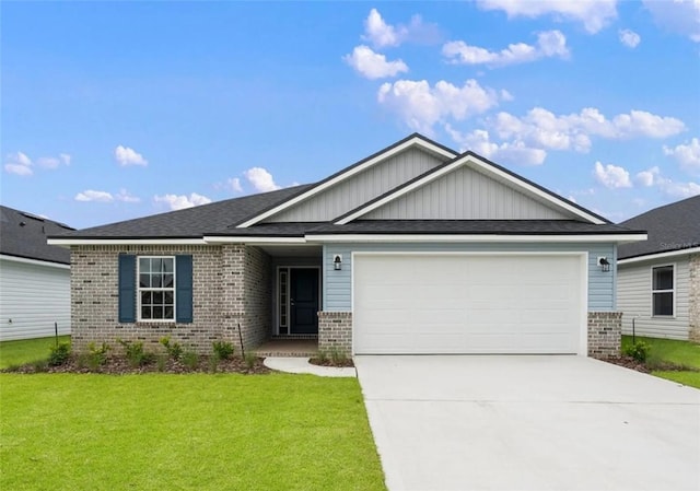 view of front of property with a garage and a front lawn