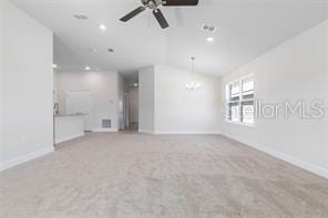 unfurnished living room featuring light carpet, vaulted ceiling, and ceiling fan