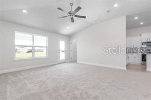 interior space featuring ceiling fan and vaulted ceiling