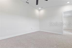 carpeted empty room with ceiling fan and vaulted ceiling