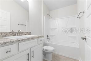 full bathroom with vanity, toilet, and washtub / shower combination