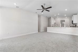 unfurnished living room with carpet flooring and ceiling fan