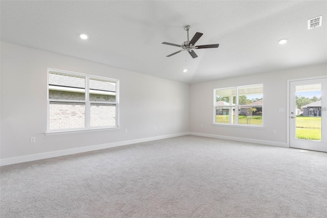 carpeted empty room featuring ceiling fan and lofted ceiling