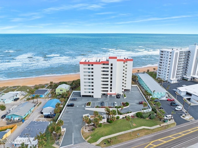 drone / aerial view with a beach view and a water view