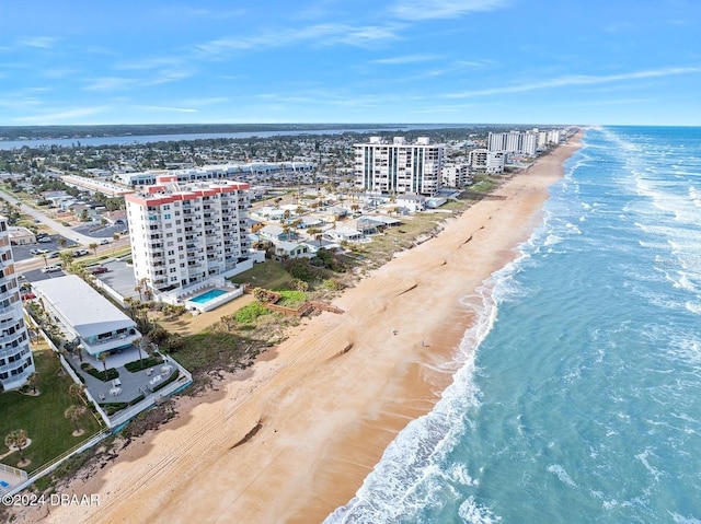 drone / aerial view featuring a water view and a beach view