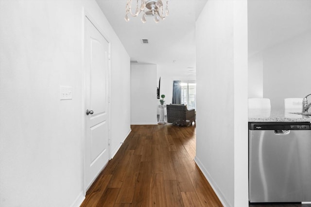 hallway featuring sink, an inviting chandelier, and hardwood / wood-style flooring