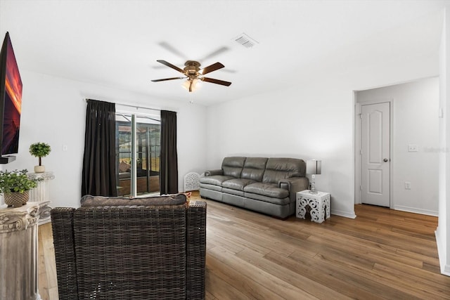 living room featuring ceiling fan and wood-type flooring